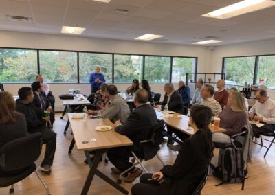 People sitting in the event space at Agency Network learning at a tax seminar